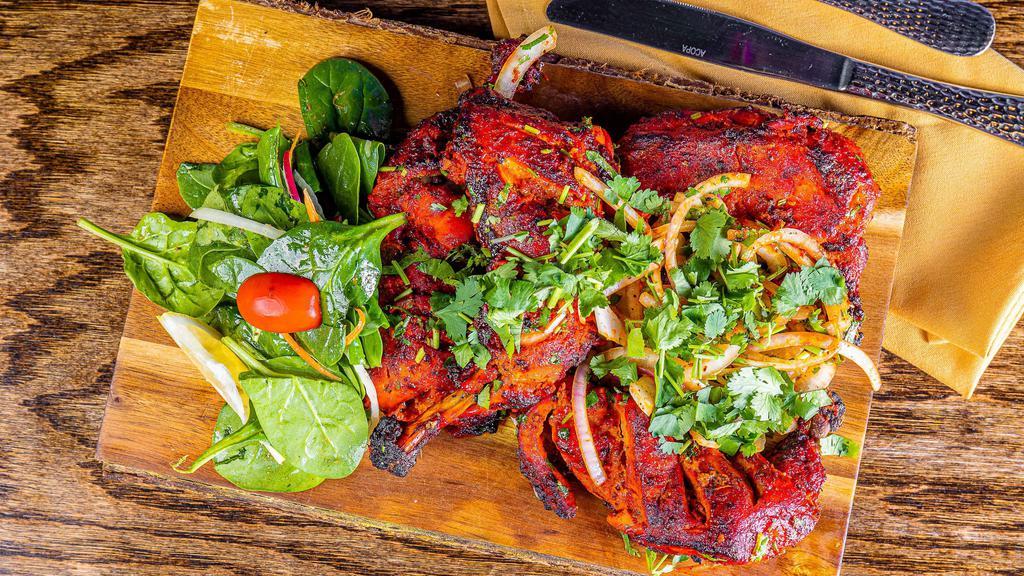 Tandoori Chicken · Whole roasted chicken marinated overnight in traditional spices, herbs and yogurt.
Served with mint and cranberry chutney.