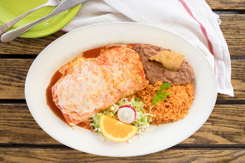 Burrito Suizo · Flour tortilla filled with sour cream, beans, & choice of beef, or chicken. Topped with melted chihuahua cheese and tomato sauce.