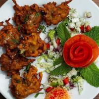 Mixed Vegetable Fritters · Mixed vegetables chopped, battered and fried to a crisp brown. Served with Mint and Tamarind...