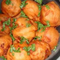 Aloo Bonda (4) · Potato dumplings mixed with spices. Served with Mint and Tamarind Chutney