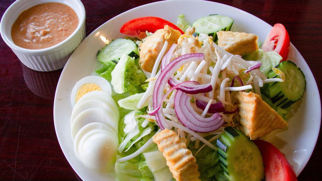 Thai Peanut Salad · Lettuce, cucumber, tomatoes, red onions, bean sprouts, fried tofu, and hard boiled eggs, served with our homemade peanut sauce.