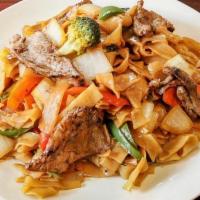 Drunken Noodle · Wide rice noodles wok tossed with seared chili, bamboo, carrots, broccoli, white onions, gre...