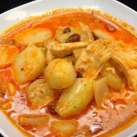 Massaman Curry · Onions, potatoes, and peanuts simmered in massaman curry and coconut milk.