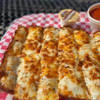 Crazy Bread (Top Seller)  · Pizza dough cooked in a rectangular pan topped with garlic and cheese. Includes one side of ...