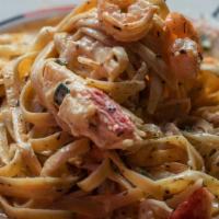 Seafood Fettuccine · Those shrimp, krab, and scallops ain't swimmin' in water, but instead a thick, creamy, alfre...