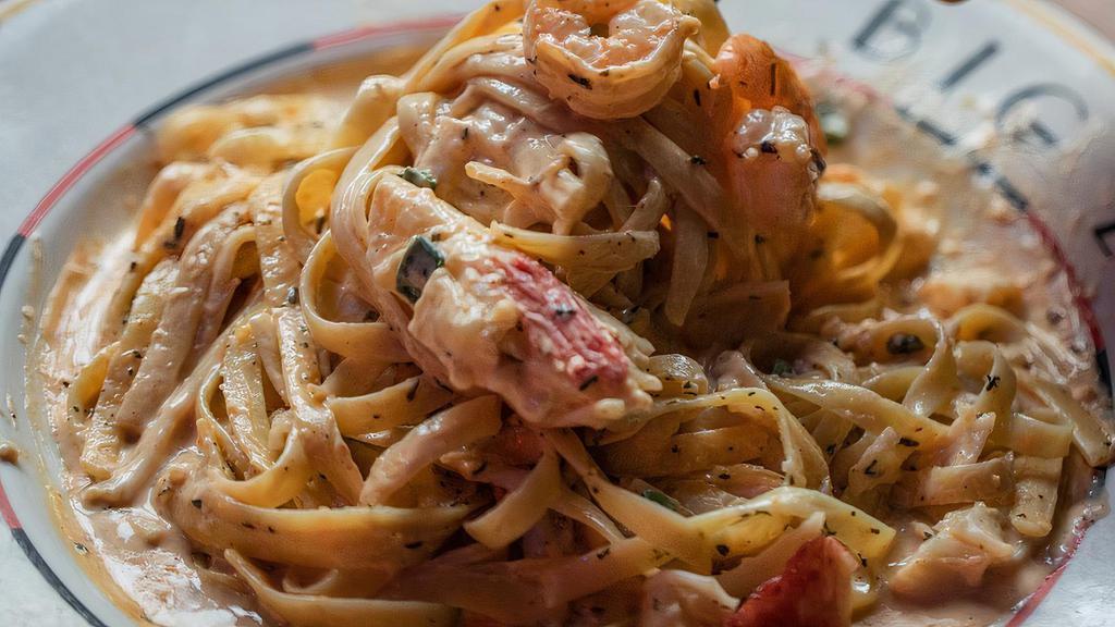 Seafood Fettuccine · Those shrimp, krab, and scallops ain't swimmin' in water, but instead a thick, creamy, alfredo sauce!.