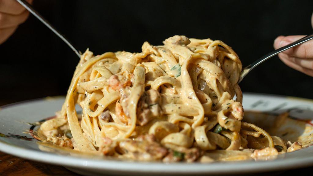 Crawfish & Andouille Fettuccine · Crawfish tail meat sautéed with spicy andouille sausage tossed with a Parmesan cream sauce.