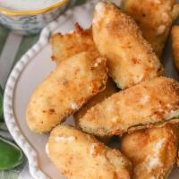 Jalapeño Poppers  · 6 pieces. Juicy jalapeno poppers breaded and filled with cheese and fried to golden perfecti...