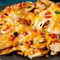 Ultimate Nachos · Tortilla chips, provolone, and cheddar, diced tomatoes and jalapenos with a side of homemade...