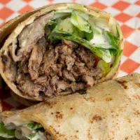 Beef Shawarma Pita · Beef Shawarma with tomatoes, onions, lettuce, pickles, spread with hummus and topped with ta...