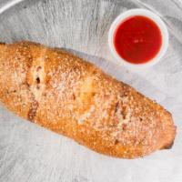 Calzone · Vegetarian. Stuffed with mozzarella cheese and homemade pizza sauce. Basted with garlic butt...