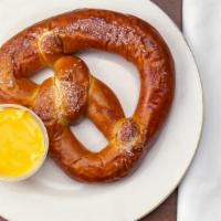 Hot Soft Pretzel · Fresh baked and salted jumbo pretzel, served with warm cheese sauce for dipping.