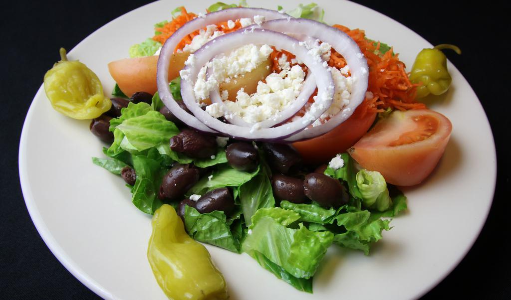 Greek Salad · Romaine, vine ripe tomato wedges, red onions, cucumber slices, shredded carrots, feta, kalamata olives, and Greek dressing.