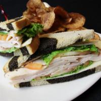 Turkey Sandwich · Smoked turkey and aged swiss, served on toasted marble rye. served with shredded iceberg let...