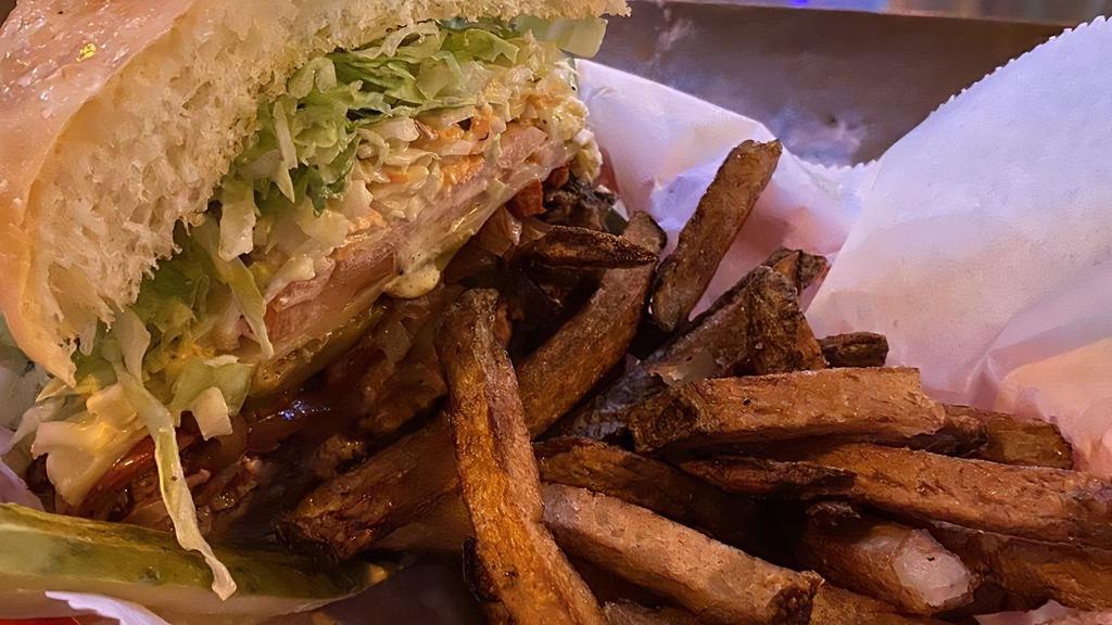 Hay Maker Jalapeño Burger · Half pound patty with cajun spices, pepper jack cheese, and jalapeños. Served with shredded iceberg lettuce, tomato, house kettle chips, and a pickle spear on a raised kaiser bun.