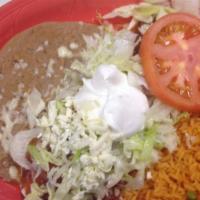 Burrito La Cascada · A flour tortilla stuffed with your choice of seasoned ground beef or shredded chicken. Toppe...