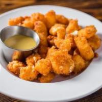 Fried Cheese Curds · Beer-battered cheddar cheese curds from ellsworth dairy. Served with honey mustard.