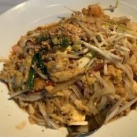 Pad Thai · Thai rice noodles, chicken, shrimp, tofu, peanuts, egg, scallions, bean sprouts, lime, chili...
