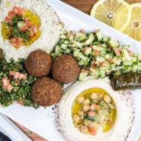 Vegetarian Plate · Hummus, baba ghanouj, choice of two salads, 3 falafels, 2 grape leaves with two pitas.