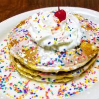 Birthday Pancakes · Vanilla icing, sprinkles, whipped cream, powdered sugar and a cherry on top.
