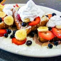 Creamy French Toast · French toast stuffed with our delicious cream cheese. Topped with vanilla icing, fresh straw...