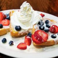 Fruity French Toast · Topped with vanilla icing and then finished with fresh strawberries and blueberries and ligh...