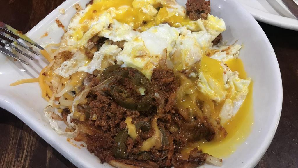 Mexi Skillet · Chorizo sausage, onions, bell peppers, tomatoes and jalapeños with hash browns and topped with shredded cheese, jalapeños Mexican-style and two eggs any style.