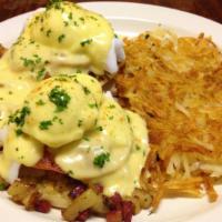 Irish Eggs Benedict · English muffin halves topped with corned beef hash, sautéed tomatoes, two poached eggs, and ...