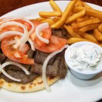 Gyro Pita · Gyro meat, onions, tomatoes and a side of our tzatziki sauce.