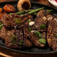 La Galbi (Short Ribs) / 갈비 · Beef short ribs marinated in sweet Korean BBQ sauce, carrot, bean.