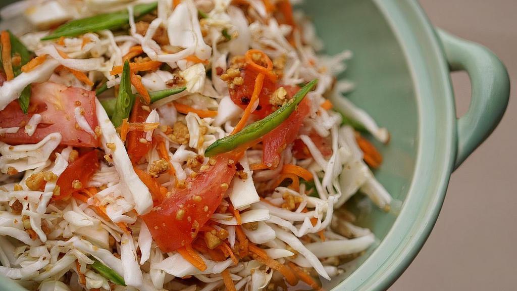 Spicy Cabbage Salad (V) · Shredded cabbage, carrots, tomatoes, roasted Thai chilies & ground peanuts tossed in vinaigrette.