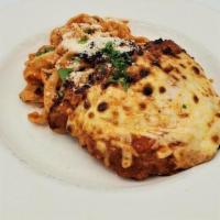 Pollo Parmigiana · Breaded chicken breast blanketed in mozzarella & tomato sauce, accompanied by homemade tagli...