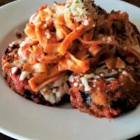 Parmigiana Di Melanzane · Breaded eggplant medallions finished with mozzarella and tomato sauce, served with homemade ...