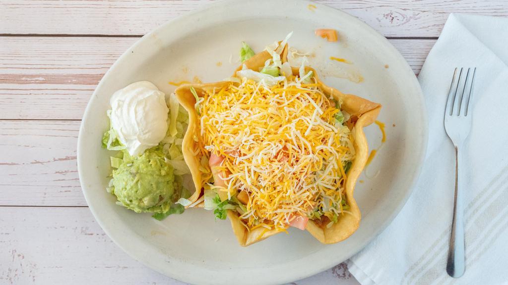 Taco Salad Lunch · Crispy flour tortilla shell with choice of shredded chicken, shredded beef, or ground beef. Topped with refried beans or rice, lettuce, tomatoes, and shredded cheese.