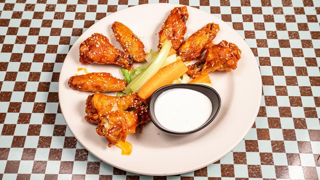 Wings O' Fire · Traditional bone-in wings tossed in buffalo sauce and sprinkled with sesame seeds. Served with carrots, celery, and our house-made blue cheese dressing.