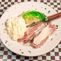 Corned Beef & Cabbage · Thick slices of corned beef in a horseradish cream sauce with buttered cabbage and mashed po...