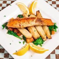 Sautéed Salmon · Wild-caught salmon with roasted potatoes, spinach, and tomatoes.