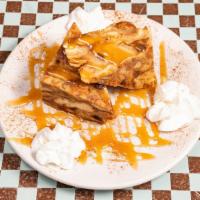 Bread Pudding · Homemade bread pudding with raisins topped with caramel and whipped cream.