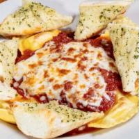 Baked Ravioli · Meat or cheese raviolis topped with our homemade red sauce and oven baked with ricotta and m...