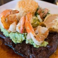 Mar Y Tierra · Our delicious grilled outer skirt steak served over ranchero sauce & topped with guacamole &...