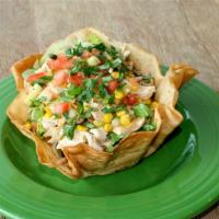 Honey Lime Chicken Salad · A flour tortilla bowl filled with lettuce then topped with seasoned grilled lime shredded ch...