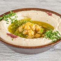 Hummus · Grounded chickpeas with tahini, sesame paste, lemon and olive, comes with pita bread.