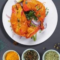 Tandoori Symphony · Fresh chicken legs and thigh, marinated in our special housemade tandoori masala, lemon juic...