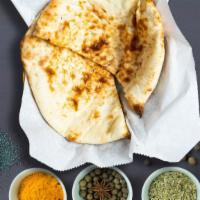 Butterlicious Naan · Traditional Indian grilled bread made of flour, milk, water, salt and baking powder, topped ...
