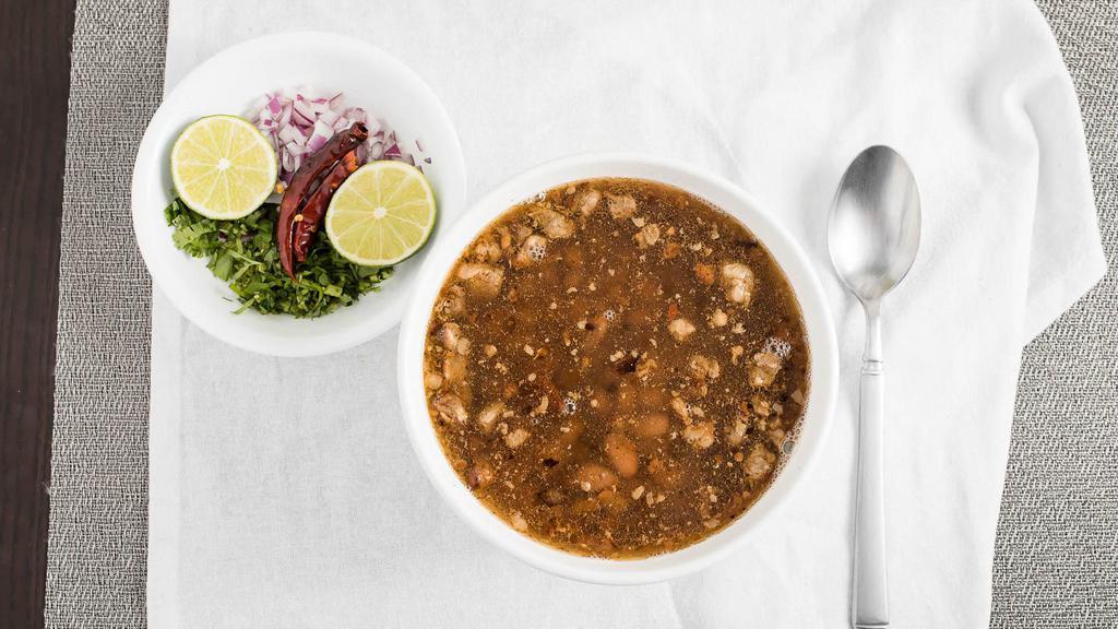 Carne En Su Jugo · Beef soup with whole beans and bacon.
