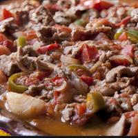 Bistec A La Mexicana · Steak strips grilled with onions, tomatoes and hot peppers.