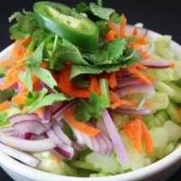 Cucumber Salad · Sliced cucumbers, red onions and shredded carrots topped with a tart vinaigrette dressing. V...