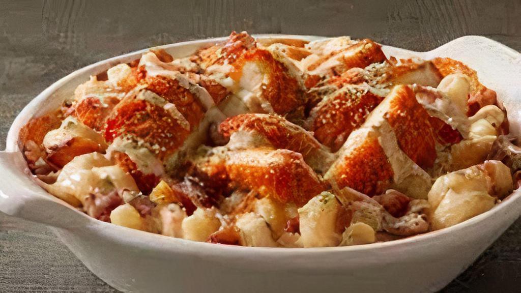 Buffalo Chicken Macaroni · Crispy chicken tossed in buffalo sauce on top of noodles with housemade cheese sauce.