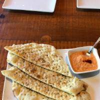 Hummus Or Red Pepper Spread · Your choice of Hummus or Red Pepper spread served with rosemary flatbread