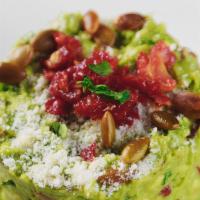 Sun Dried Tomato & Roasted Pumpkin Seed Guacamole · Guacamole with sun-dried tomatoes, roasted pumpkin seeds, lime juice and cilantro. Sprinkled...